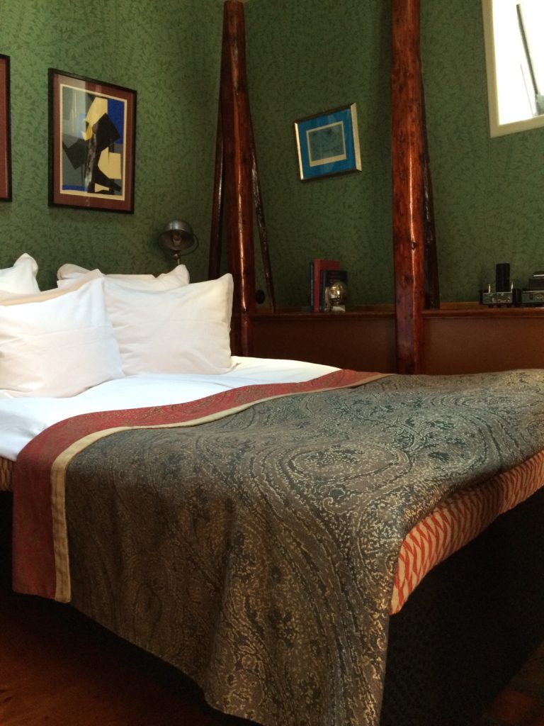 Indretningen med det mørke genbrugstræ står i stærk kontrast til de til tider ensformige hotelværelser, som er blottet for personlighed.